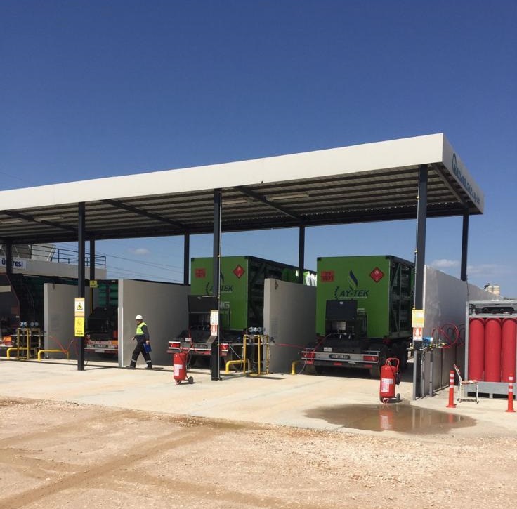 CNG filling facility with green mobile units under protective canopy