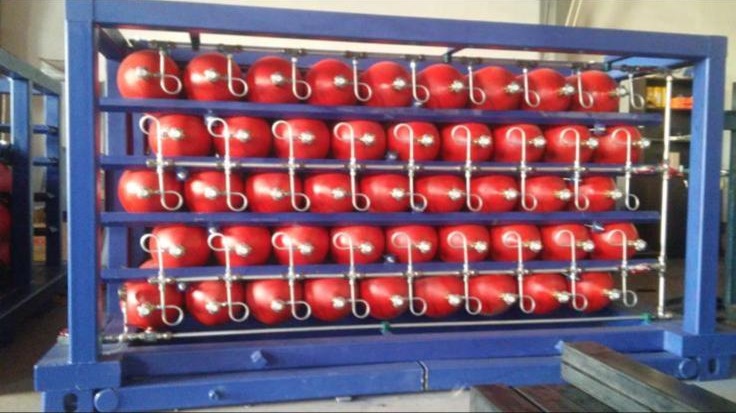 Red CNG cylinders in blue frame structure, indoor view