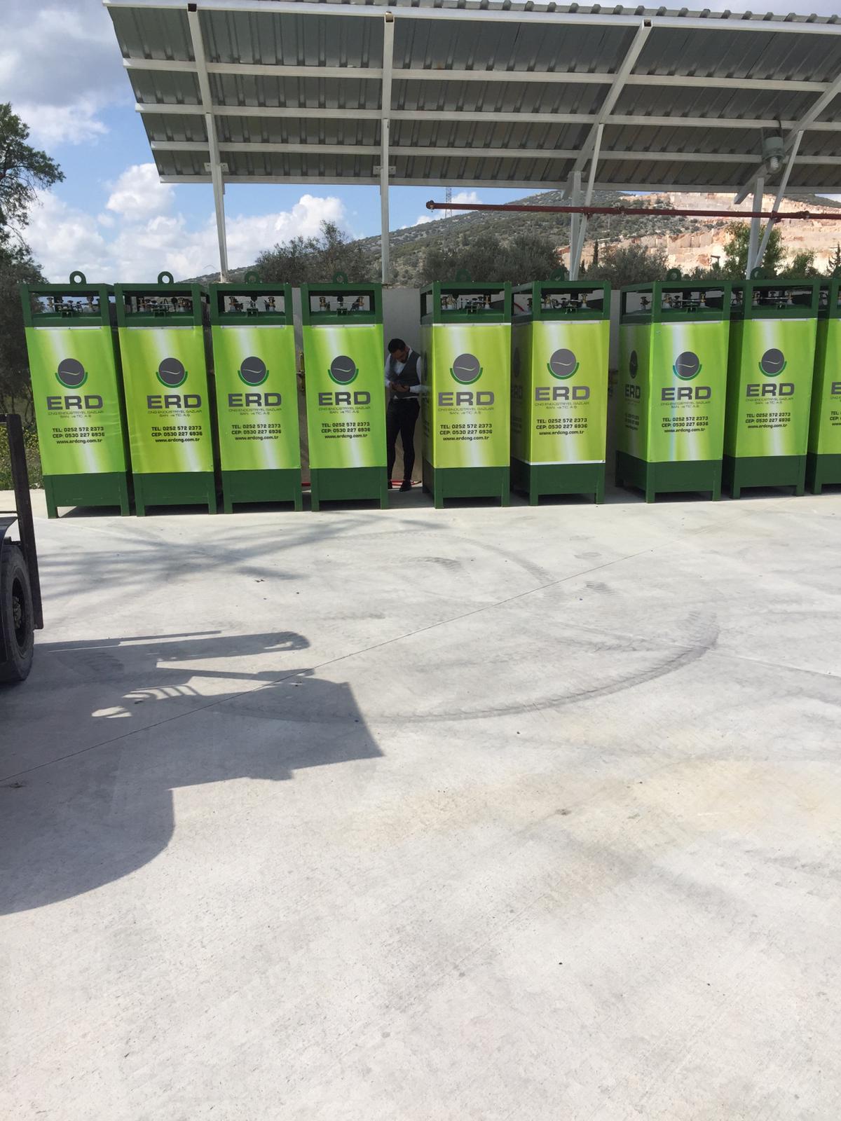 ERD branded CNG dispensers with maintenance worker under canopy
