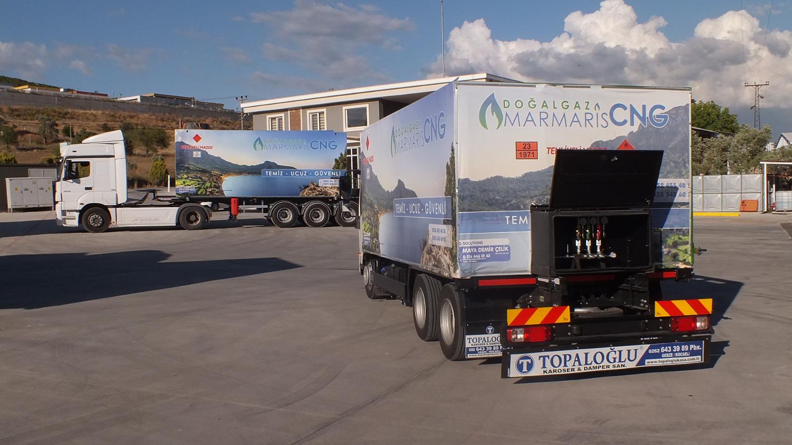 Multiple trucks with MARMARİS CNG scenic branding at facility with TOPALOĞLU trailer