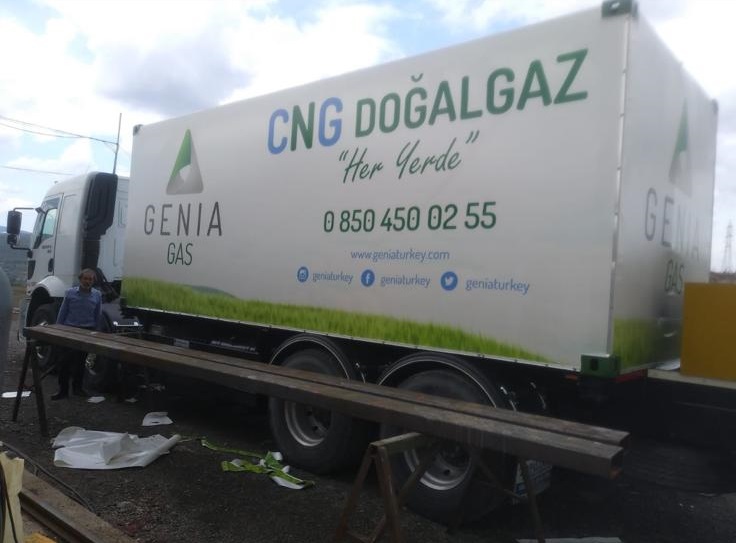 GENIA GAS branded white trailer with green grass graphics and contact information