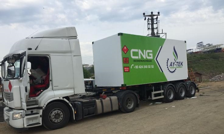 White truck with AY-TEK branded green and white CNG trailer container